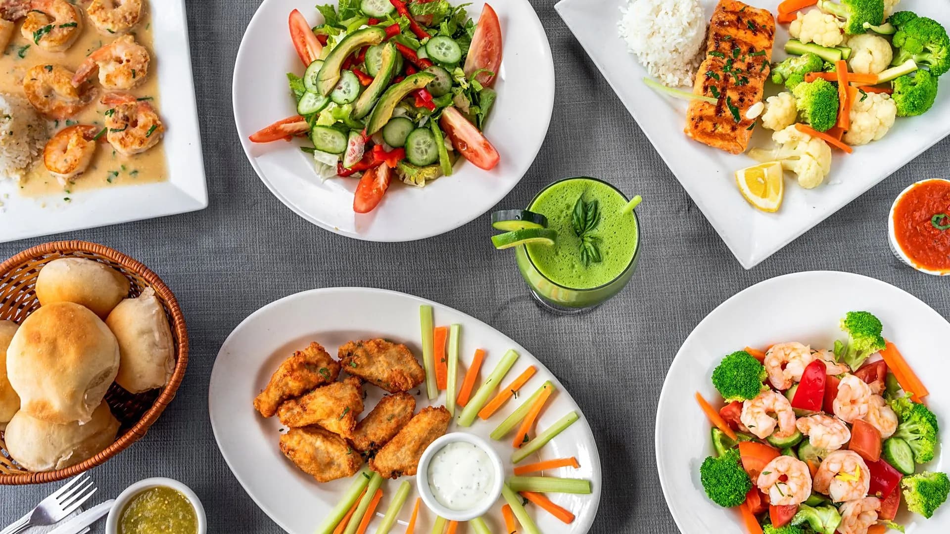 Shrimp scampi, salmon with vegetables, a fresh salad, chicken wings, dinner rolls and a green juice from P Mother's Family Restaurant in Uniondale